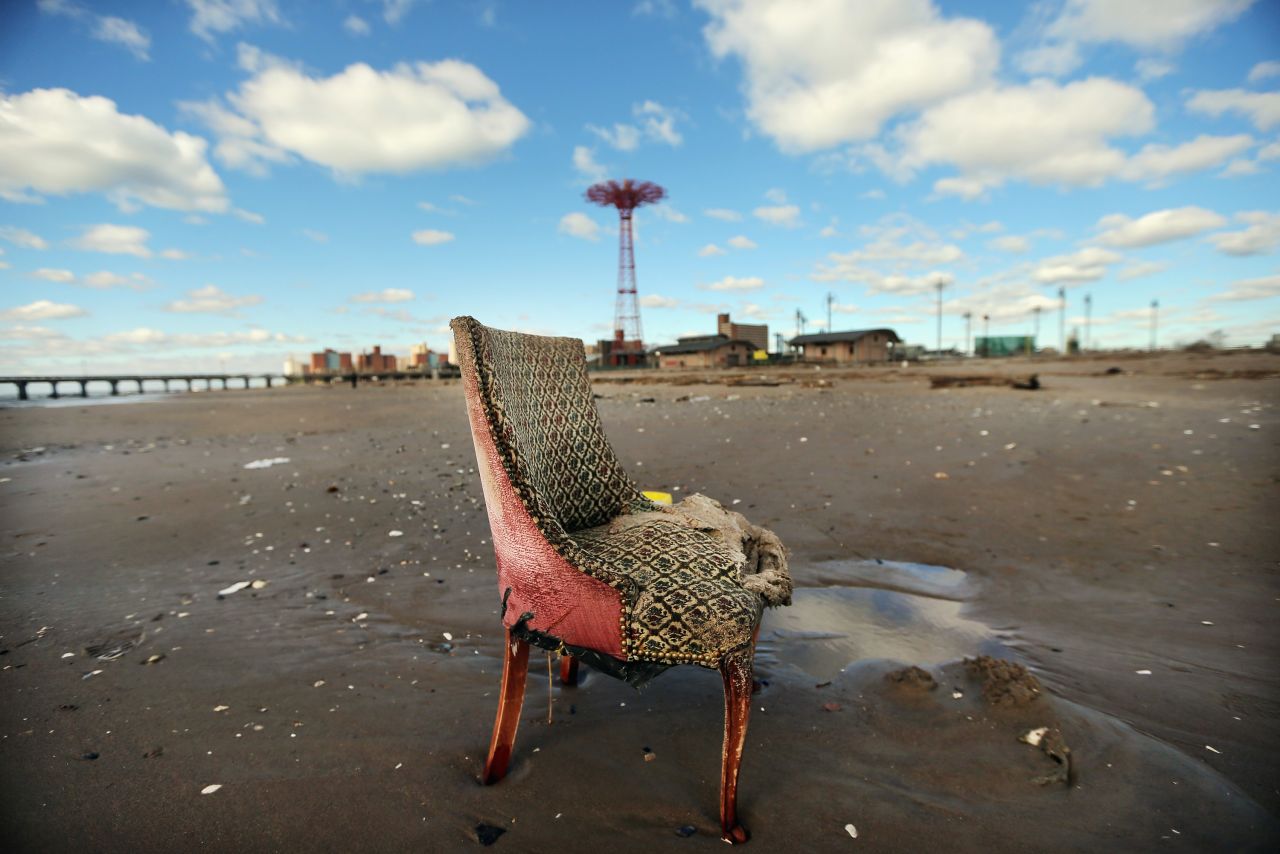A damaged chair sits on the beach in low-lying Coney Island on Saturday.