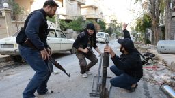 Syrian rebel fighters set a home made rocket in Aleppo's northern Izaa quarter, on November 3, 2012.