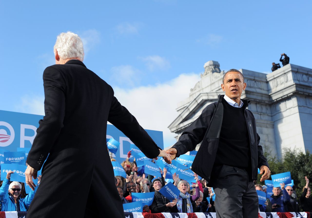 Obama is greeted by former President Bill Clinton during a campaign rally in Concord, New Hampshire, on Sunday, November 4. Obama and Romney darted from swing state to swing state, trying to fire up enthusiasm among supporters and win over any last wavering voters before Election Day.