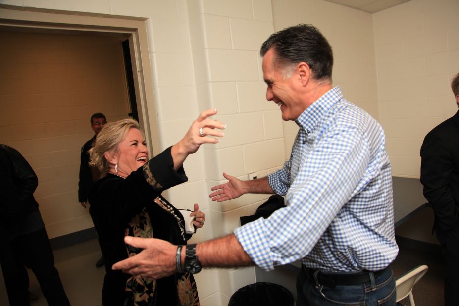 Romney hugs Kelly Owen, wife of singer Randy Owen of Alabama, backstage before a hurricane relief event in Kettering, Ohio, on Oct. 30, 2012. 