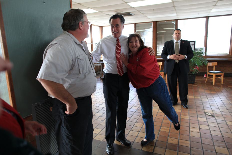 Romney is hugged by restaurant owner Rhoda Elliott during a visit to her struggling business in Richmond, Virginia, on Nov. 1, 2012. 