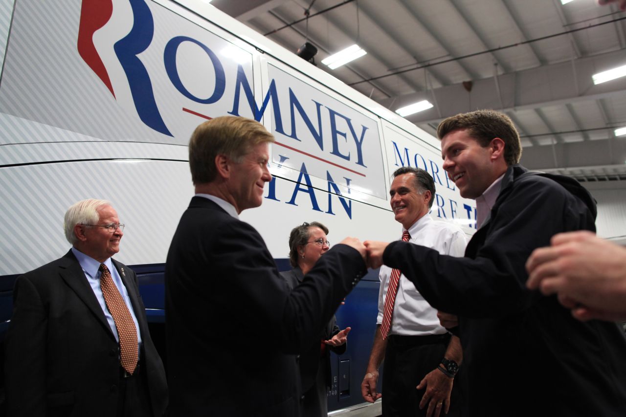 Romney smiles backstage with Virginia Gov. Bob McDonnell, left, who gives a fist bump to Romney aide Garrett Jackson after a rally in Richmond, Virginia, on Nov. 1, 2012.