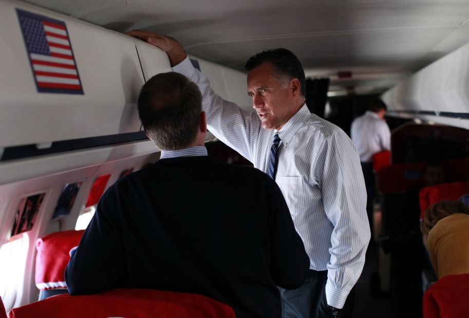 Romney talks with senior advisor Bob White aboard his campaign plane during a flight from New Hampshire to Wisconsin, Nov. 3, 2012. 
