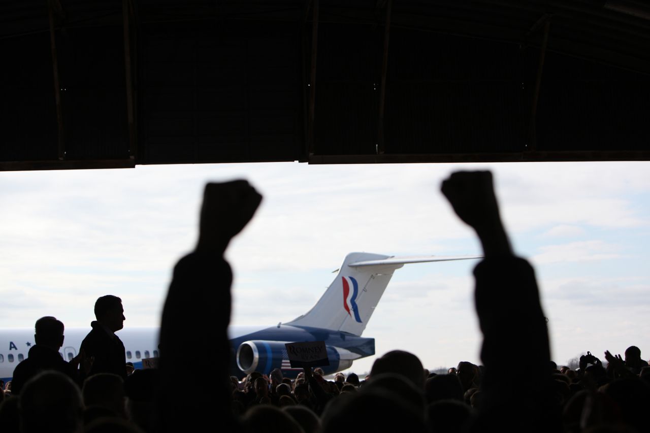 Romney is silhouetted on stage as supporters cheer during his airport rally in Dubuque, Iowa, on Nov. 2, 2012. 