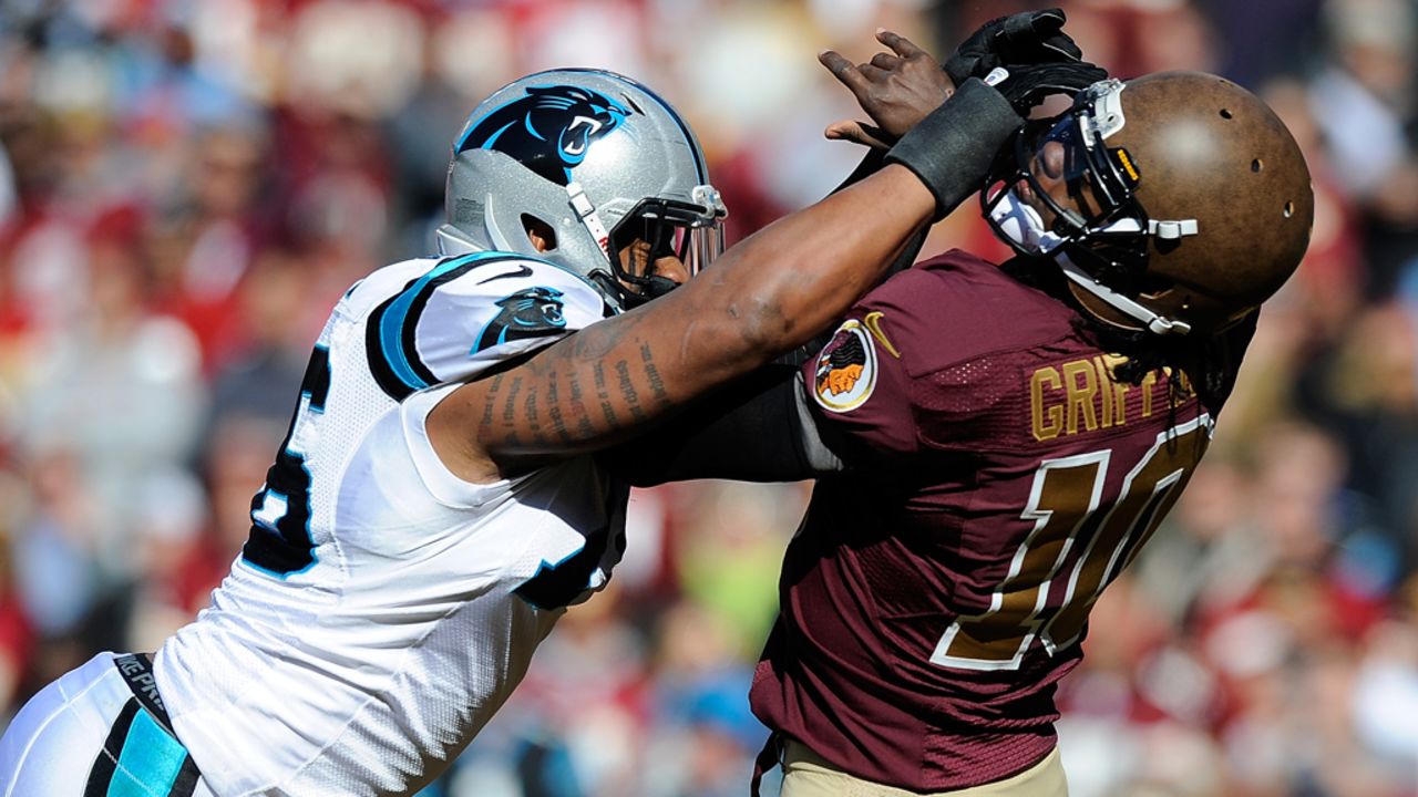 Greg Hardy of the Carolina Panthers hits Robert Griffin III of the Washington Redskins and is charged with a roughing-the-passer penalty during the first half at FedEx Field on Sunday in Landover, Maryland. 