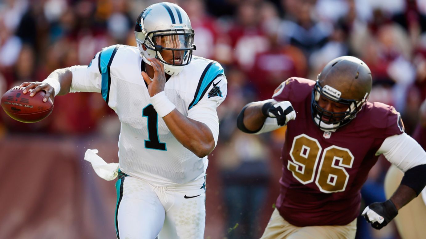 Quarterback Cam Newton of the Panthers scrambles while being chased by nose tackle Barry Cofield of the Redskins during the second quarter on Sunday.