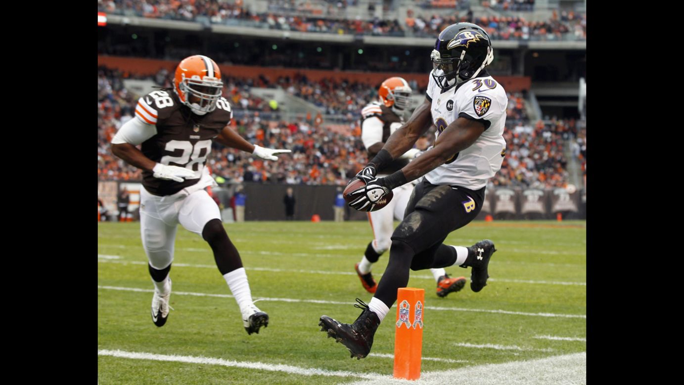 Running back Bernard Pierce of the Ravens scores a touchdown in front of defensive back Usama Young of the Browns on Sunday.