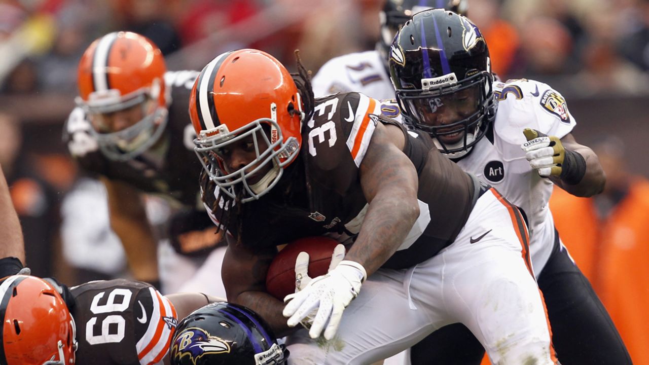 Running back Trent Richardson of the Browns runs the ball as he is hit by defenders Arthur Jones and Dannell Ellerbe of the Ravens on Sunday.