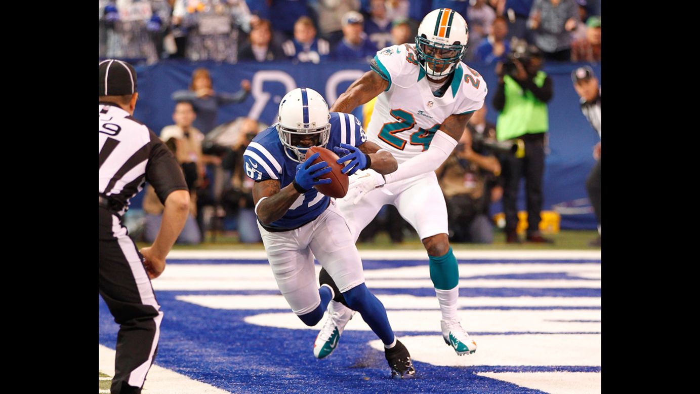 Reggie Wayne of the Colts catches a first quarter touchdown in front of Sean Smith of the Dolphins on Sunday.