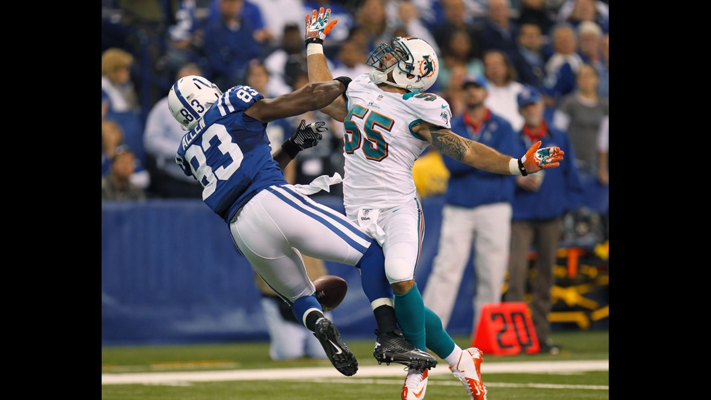 Koa Misi of the Dolphins defends a first quarter pass against Dwayne Allen of the Colts but was called for pass interference on Sunday.