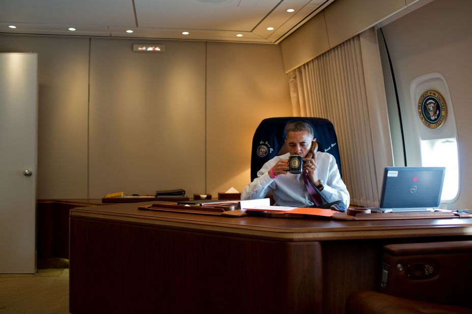 President Barack Obama convenes a conference call to discuss the response to Hurricane Sandy in his office aboard Air Force One during the flight to New Hamsphire on Oct. 27, 2012.