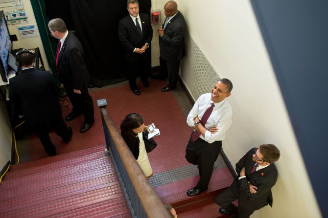 Obama holds backstage with Nancy-Ann DeParle, Deputy Chief of Staff for Policy, and traveling aide Bobby Schmuck prior to an event at the Elm Street Middle School in Nashua, New Hampshire, on Oct. 27, 2012. 