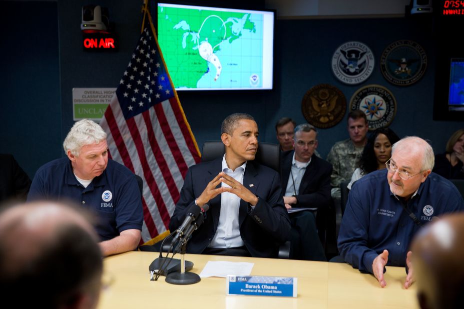 Obama, seated between FEMA Administrator Craig Fugate (r) and Richard Serino, FEMA deputy administrator, (l) receives an update on the response to Hurricane Sandy at the National Response Coordination Center at FEMA headquarters in Washington on Oct. 28, 2012.