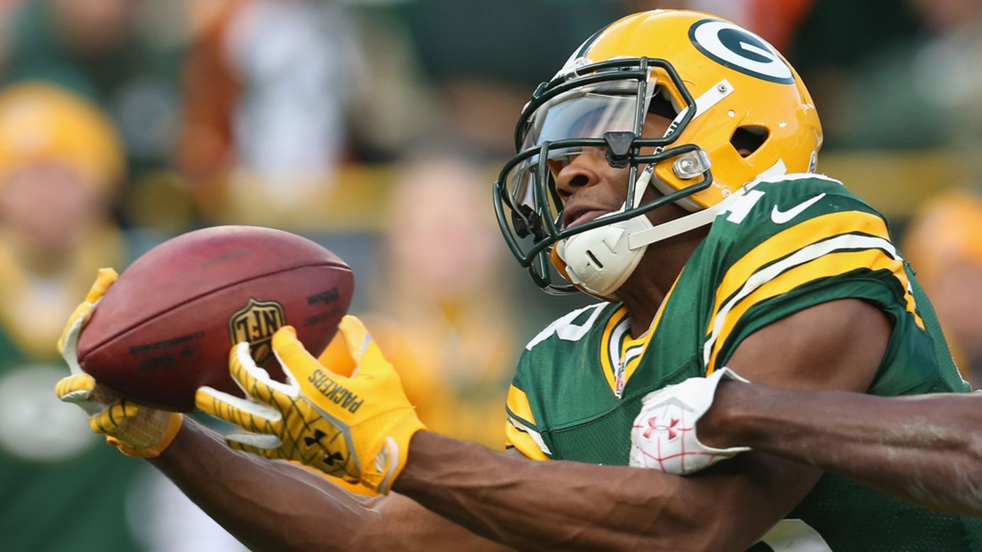 Randall Cobb of the Green Bay Packers catches a touchdown pass against the Arizona Cardinals at Lambeau Field on Sunday in Green Bay, Wisconsin.