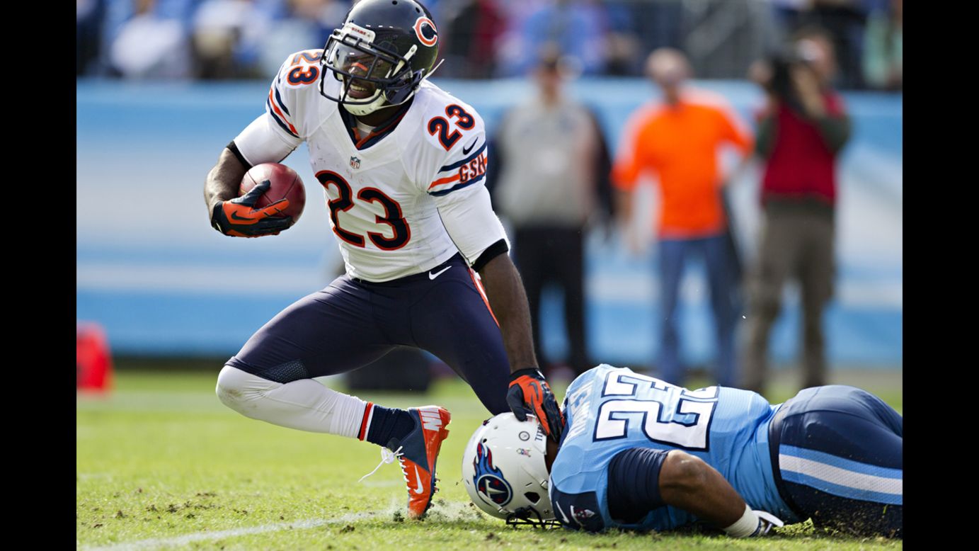 Devin Hester of the Bears is tackled by Jamie Harper of the Titans on Sunday.