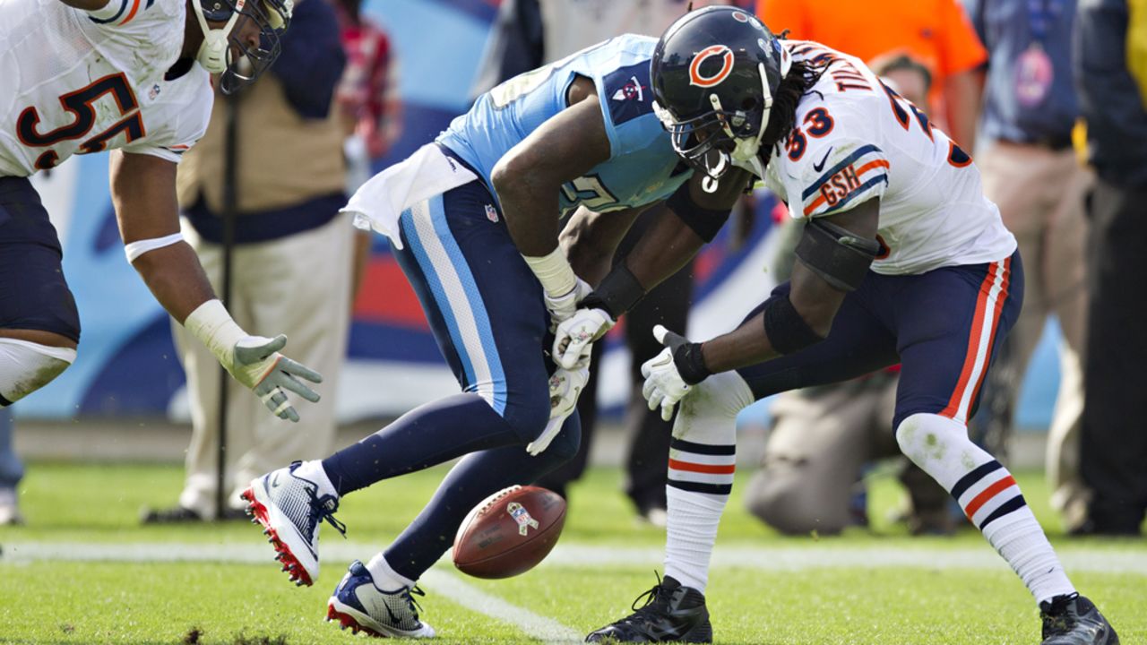 Chris Johnson of the Titans fumbles the ball after being hit by Charles Tillman of the Bears on Sunday.