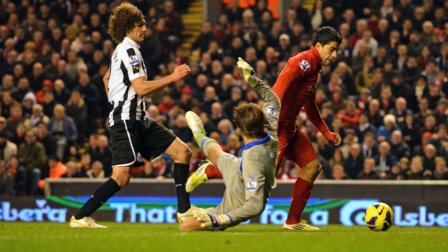 Liverpool striker Luis Suarez scores the equalizer against Newcastle after evading Fabricio Coloccini and goalkeeper Tim Krul.