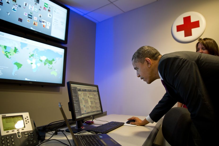 Obama "tweets" a thank you message to people making donations to the Red Cross during his visit to the Disaster Operation Center of the Red Cross at national headquarters in Washington on Oct. 30, 2012.