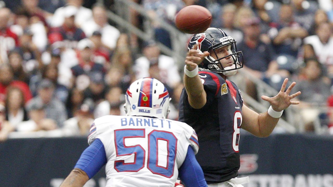 Texans quarterback Matt Schaub completes a pass while being pressured by Bills linebacker Nick Barnett.