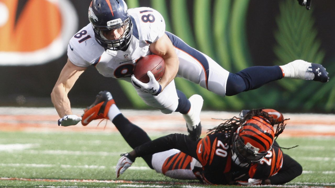 Joel Dreessen of the Broncos runs the ball upfield against Reggie Nelson of the Bengals during their game on Sunday.