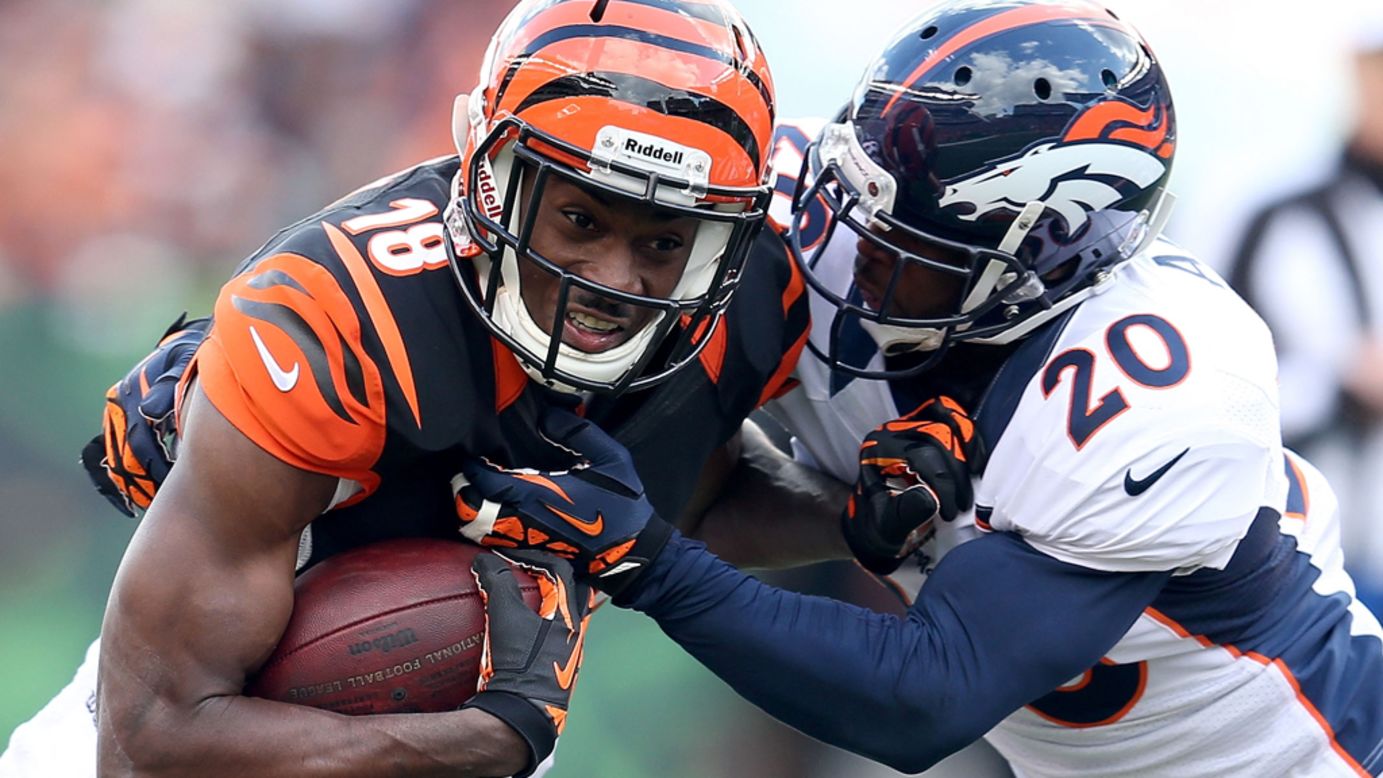 Bengals wide receiver A.J. Green runs with the ball while being defended by Mike Adams of the Broncos.