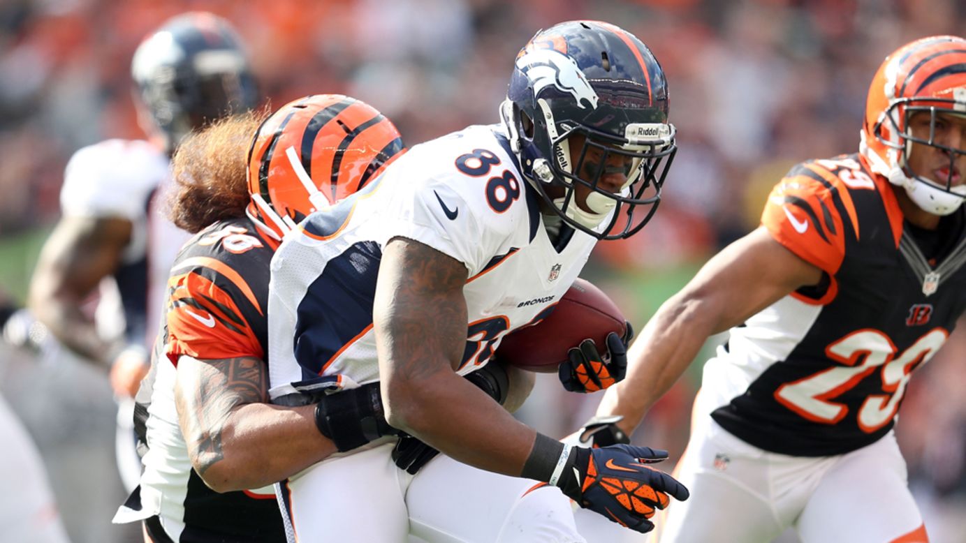 Demaryius Thomas of the Broncos runs with the ball while defended by Rey Maualuga of the Bengals.