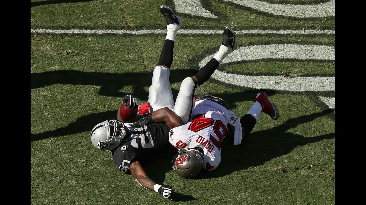 Raiders running back Darren McFadden is tackled by Lavonte David of the Buccaneers.