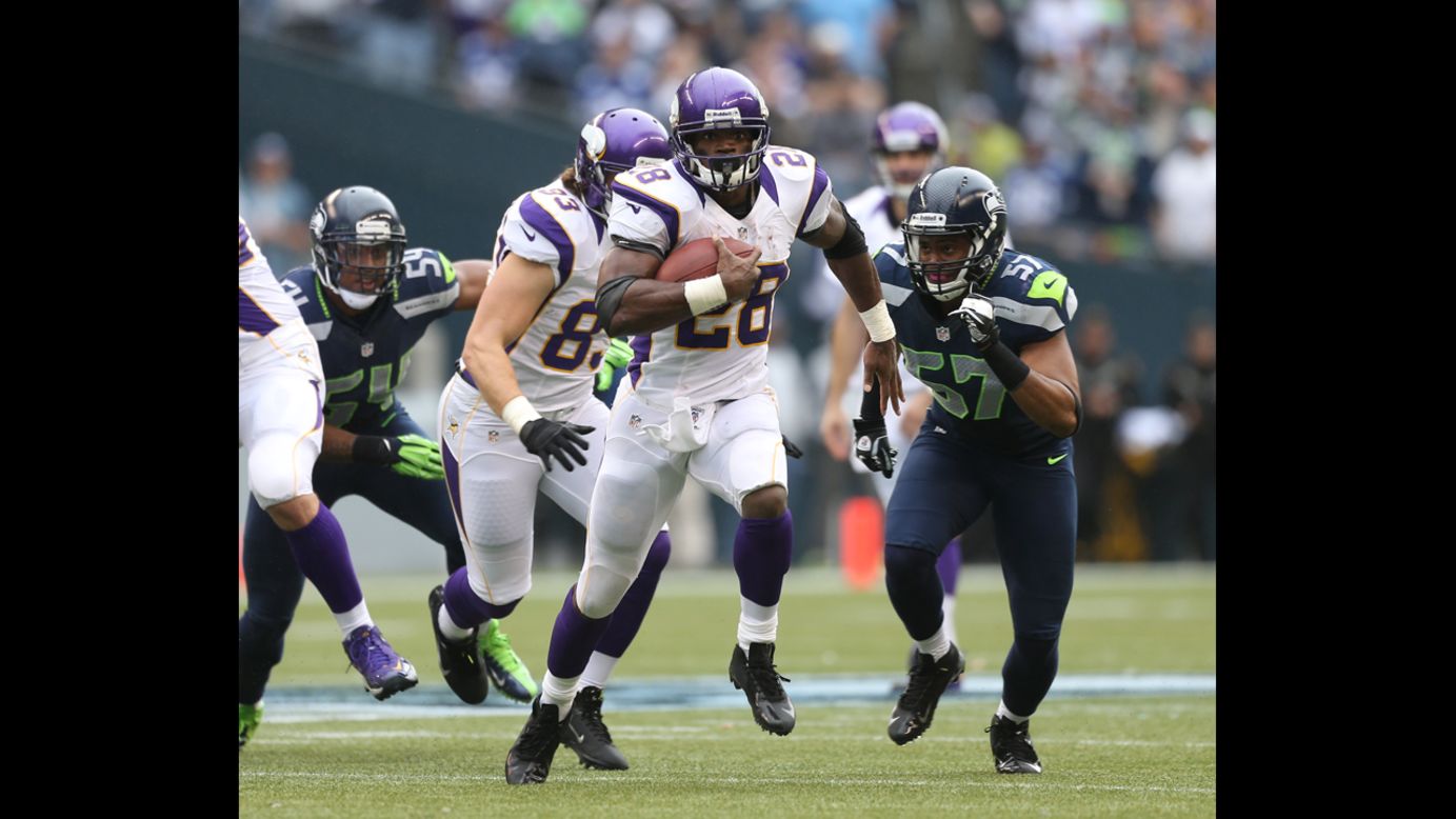 Running back Adrian Peterson of the Vikings rushes against the Seahawks on Sunday.