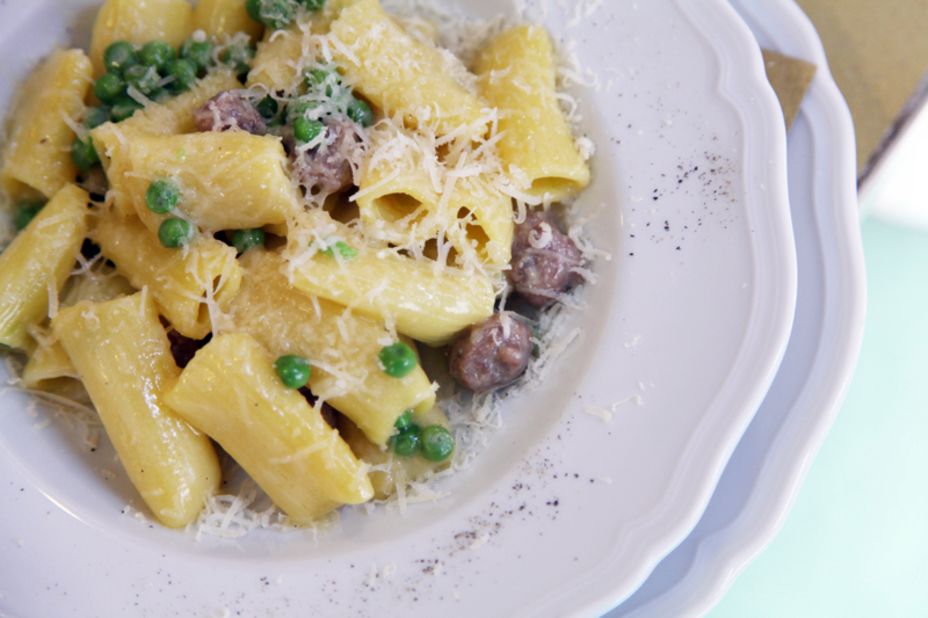 Freshly made rigatoni with a white ragout of cannellini beans, rosemary, small sausage meatballs and peas is a simple, yet unforgettable, dish.