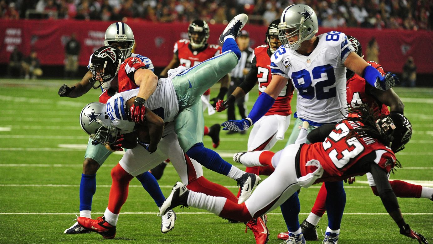 Lance Dunbar of the Cowboys is tackled by Falcons defenders Sunday night.