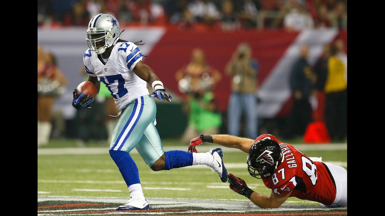 Dwayne Harris of the Cowboys returns a punt past Tommy Gallarda of the Falcons.