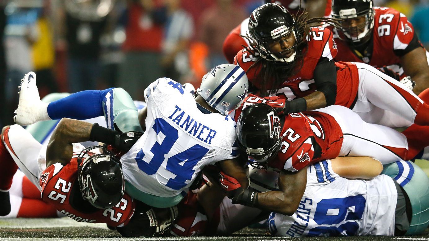 Phillip Tanner of the Cowboys is stopped short on a third down Sunday against the Falcons.