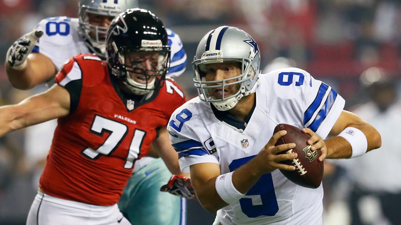 Quarterback Tony Romo of the Dallas Cowboys is pressured out of the pocket by Kroy Biermann of the Falcons.