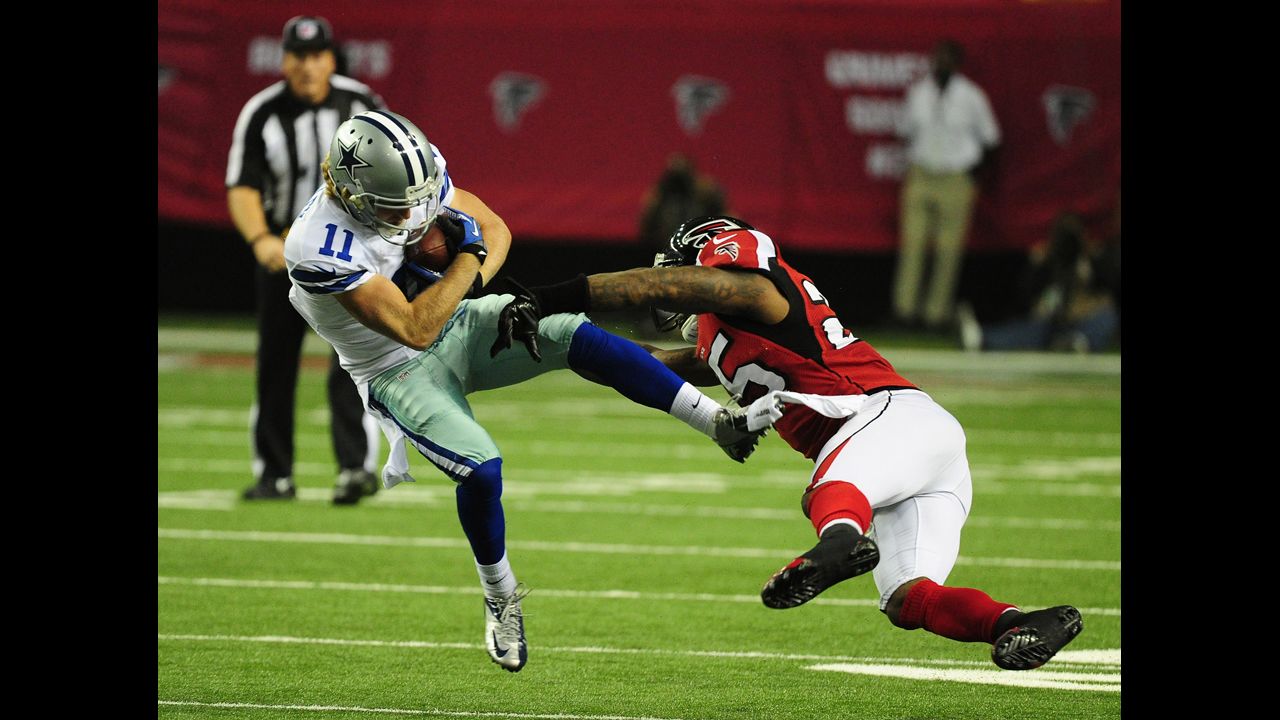 Cole Beasley of the Cowboys is tackled by William Moore of the Falcons on Sunday.