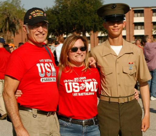 Marine Pfc. J. S. Gigliano stands with his mother and grandfather after graduating last October. His mother and gradfather are former Marines.