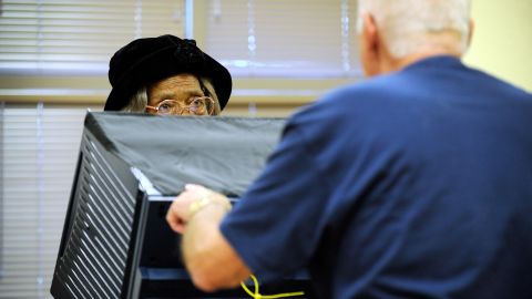 Phignora Brown, left, gets assistance from a polling station worker as she casts her ballot on the first day of early voting in Las Vegas on October 20.