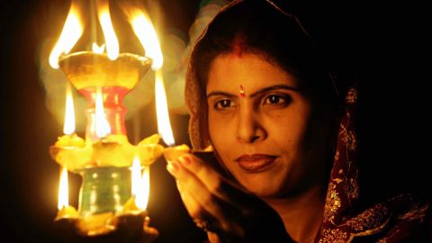 diwali celebrates oil lamp woman