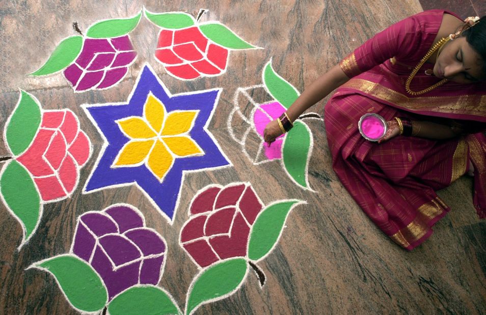 Brightly colored rangolis are drawn on the ground at the entrances to homes and offices during Diwali, using the fingers and colored flour, rice power, rice grains, flower petals, powders and chalk. They are usually geometric symmetrical designs and symbols of nature such as peacocks, butterflies, animals and flowers. 