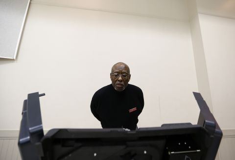 Precinct official Bill Partlow inspected a voting machine before polls open Tuesday in Pineville, North Carolina. 