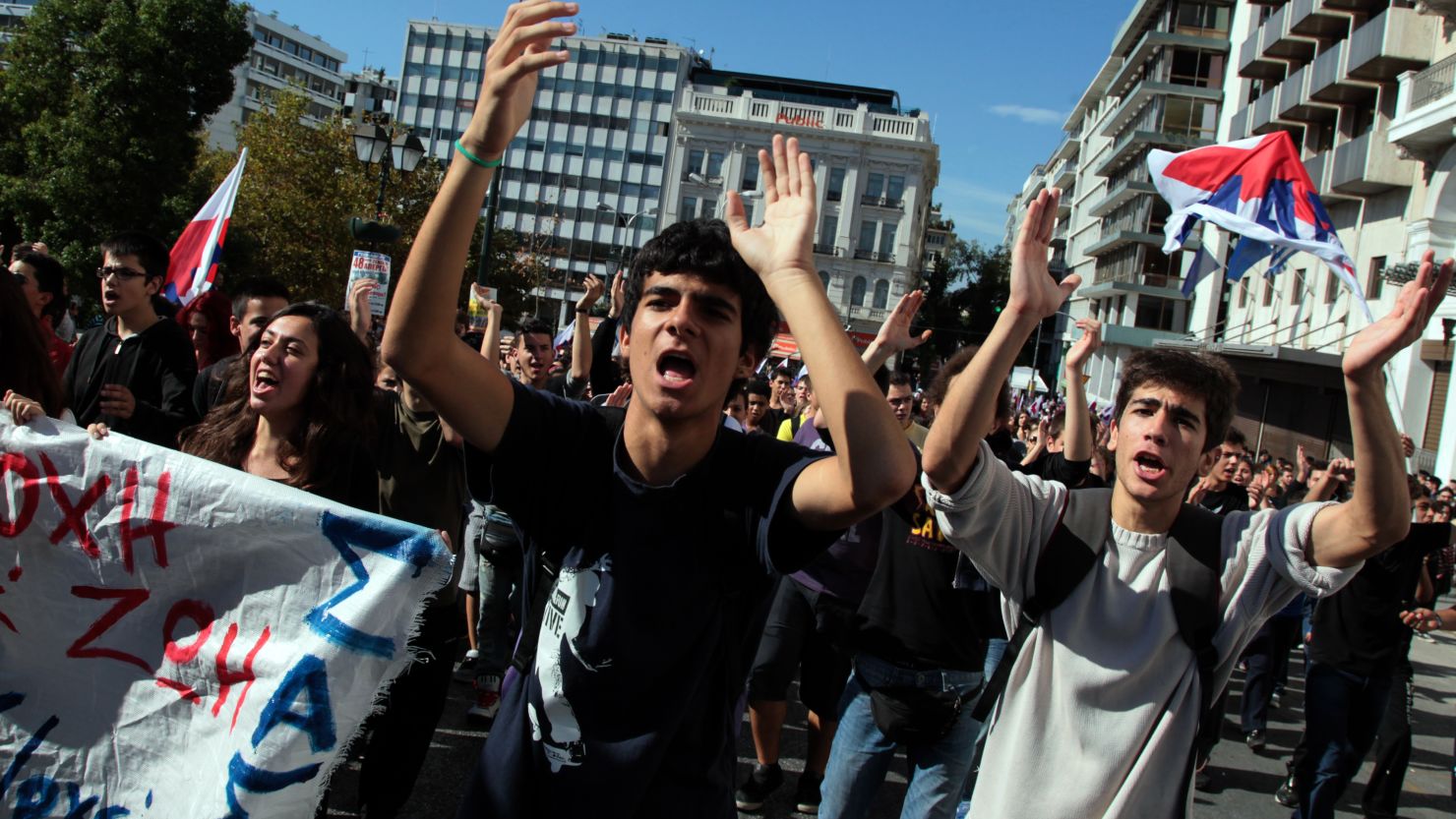 Demonstrators shout slogans Tuesday in front of the Greek parliament in Athens.
