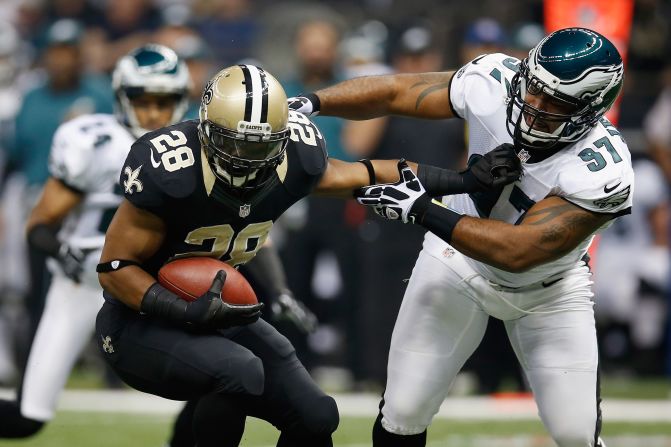 Mark Ingram of the Saints slips a tackle by Eagles defender Cullen Jenkins.