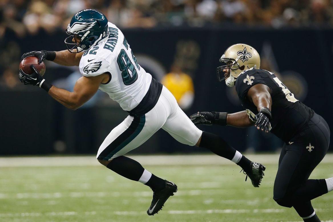 Clay Harbor of the Eagles makes a catch over Curtis Lofton of the Saints.