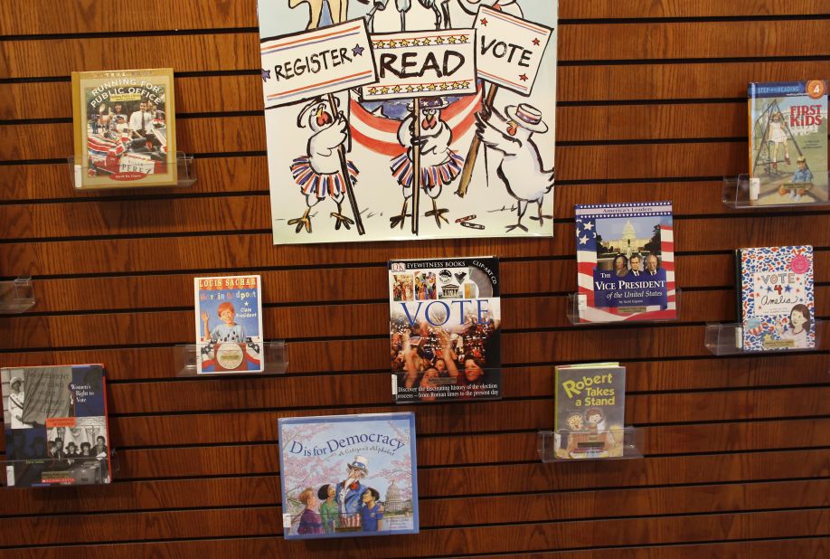 Children's books about politics lined a wall where citizens waited to cast their vote in Janesville, Wisconsin.