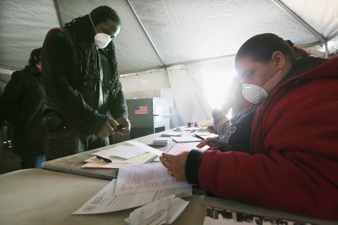 Jesse James, whose home was damaged by Superstorm Sandy, prepared to vote in a makeshift tent set up as a polling place in Rockaway Park, a neighborhood in Queens, New York. 