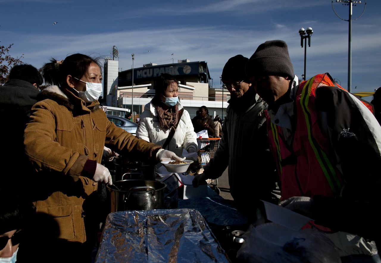 People wait in line for food at a distribution center at Coney Island.