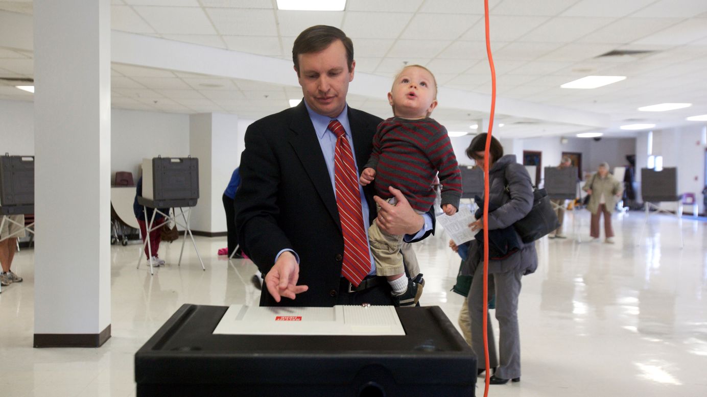Three-term Democratic congressman and U.S. Senate candidate Chris Murphy casts his vote with his 1-year-old son Rider at Cheshire High School in Cheshire, Connecticut.