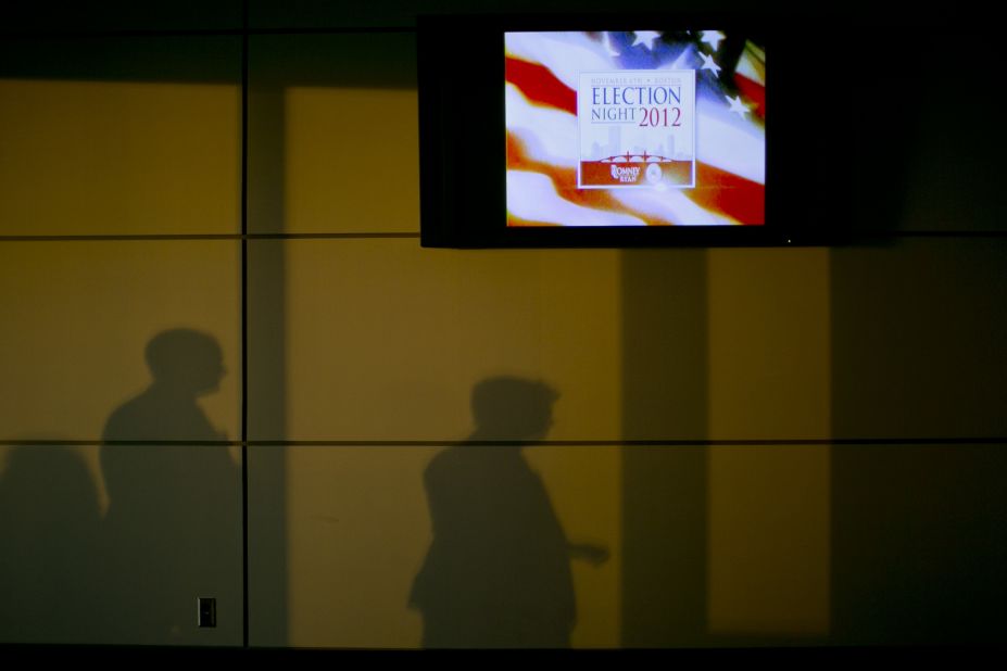 Shadows were cast on a wall next to a television advertising "Election Night 2012" inside the Boston Convention & Exhibition Center, where Republican presidential candidate Mitt Romney was scheduled to speak Tuesday evening.