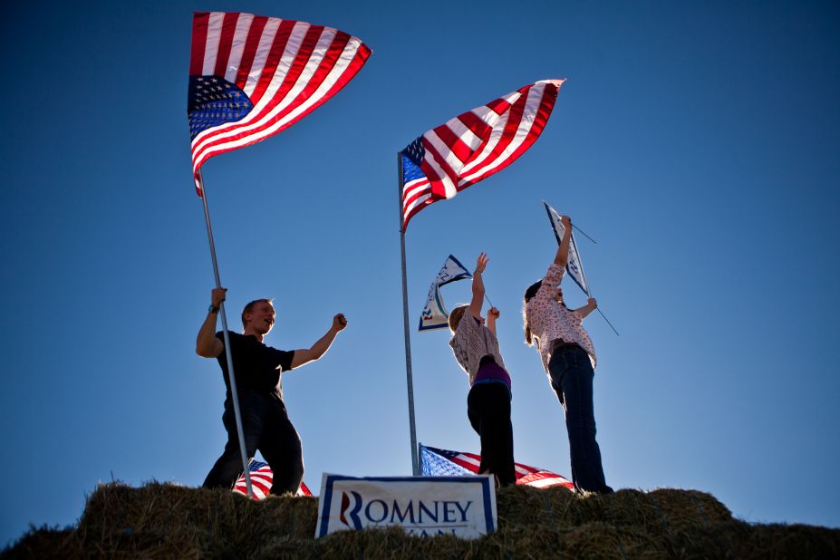 Justin Stucki, Leah Quirk, and Kenady Pettingill, left to right, urged drivers to vote for Republican presidential candidate Mitt Romney in Spanish Springs, Nevada. 