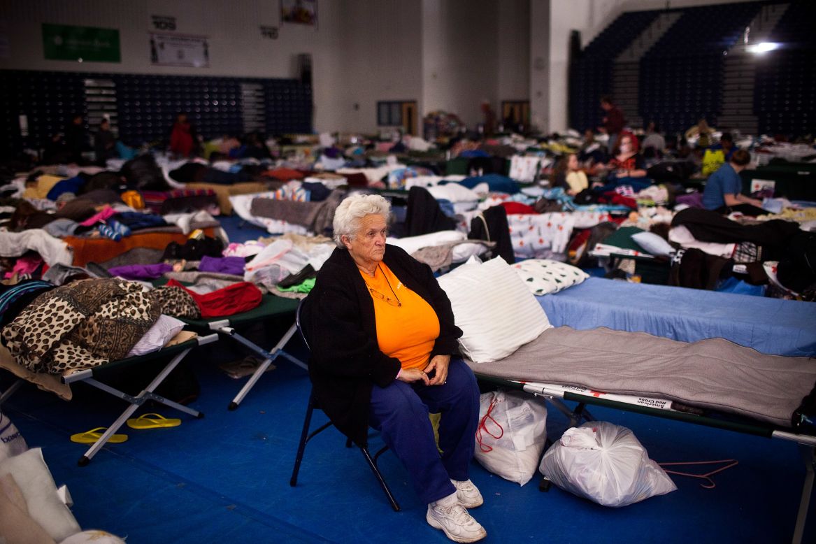 Ruth Hawfield sits next to her cot Monday in a Red Cross evacuation shelter at Toms River High School.