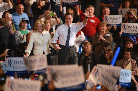 Romney and his wife, Ann, greet supporters at a rally late Monday in Manchester, New Hampshire. 